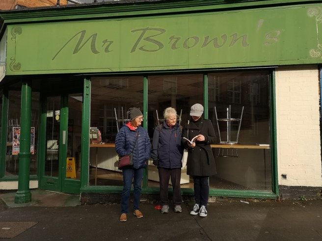 Standing outside Mr Browns where the best bacon sandwich is made.